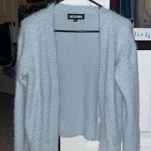 Adult Small thin cardigan jacket, very light blue and comes down to you hips